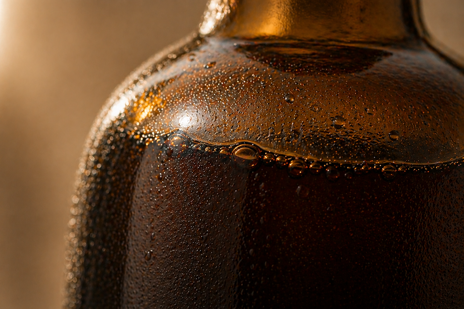 Close-up of antique olive glass bottle with condensation droplets